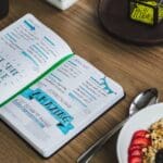 An Entrepreneurs planner (bullet journal) filled with notes and appointments, most of which are assignable to a virtual assistant.