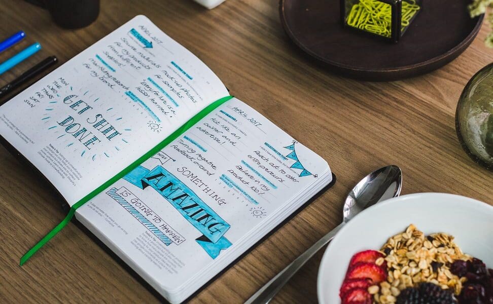 An Entrepreneurs planner (bullet journal) filled with notes and appointments, most of which are assignable to a virtual assistant.